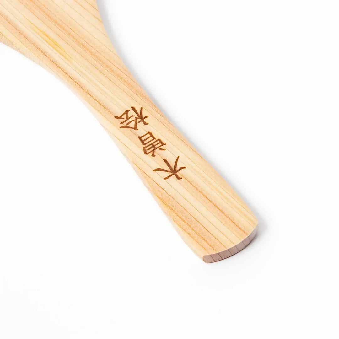 Japanese hinoki wood rice paddle with natural grain and engraved characters, lightweight and smooth for serving cooked rice