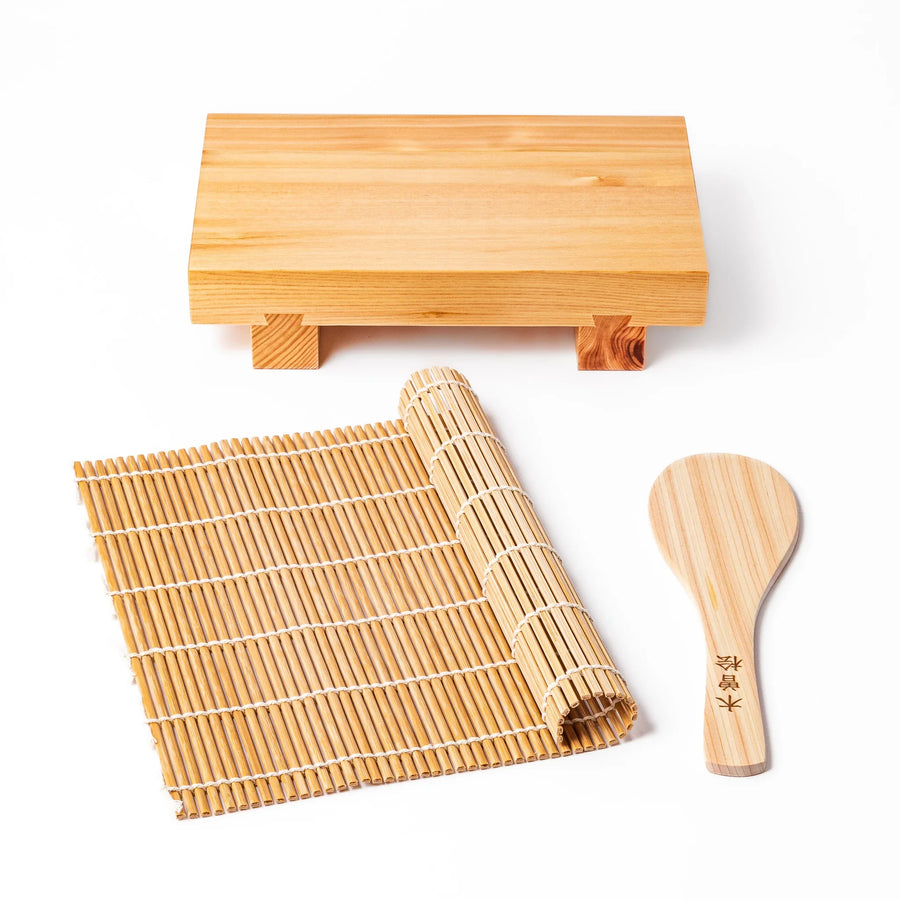 Japanese sushi making set with wooden board, bamboo rolling mat, and hinoki rice paddle for preparing and serving sushi