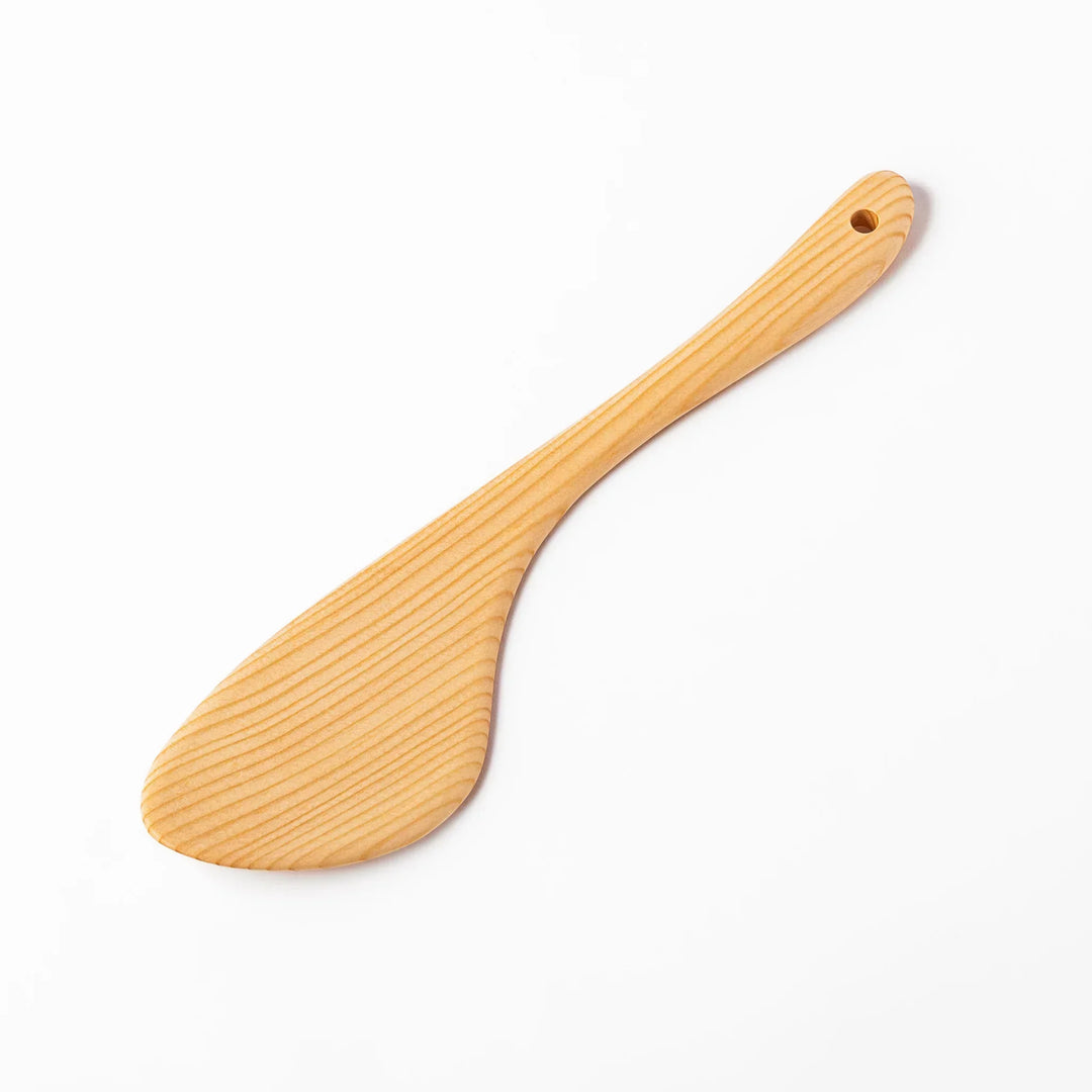Lightweight hinoki wood spatula with fine grain and engraved Japanese handle for authentic kitchen use.