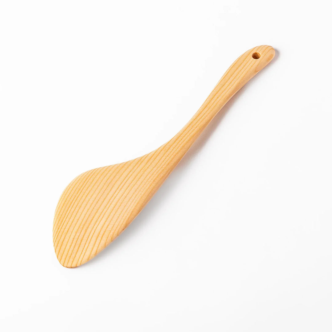 Lightweight hinoki wood spatula with fine grain and engraved Japanese handle for authentic kitchen use.