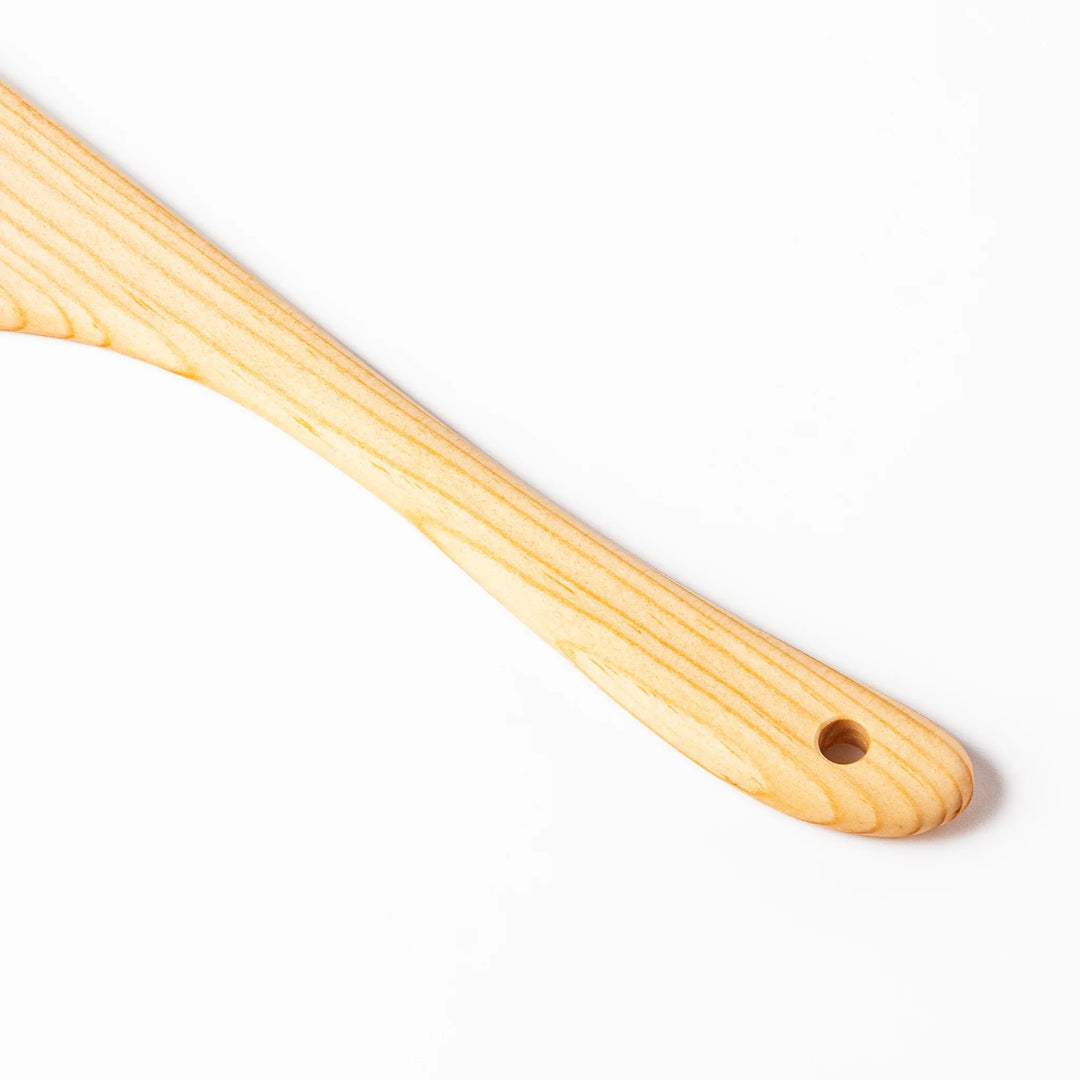 Lightweight hinoki wood spatula with fine grain and engraved Japanese handle for authentic kitchen use.