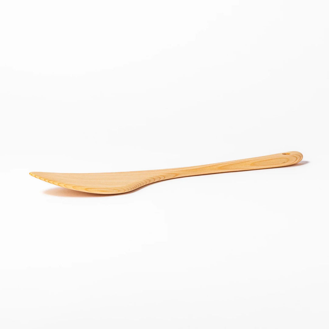 Lightweight hinoki wood spatula with fine grain and engraved Japanese handle for authentic kitchen use.