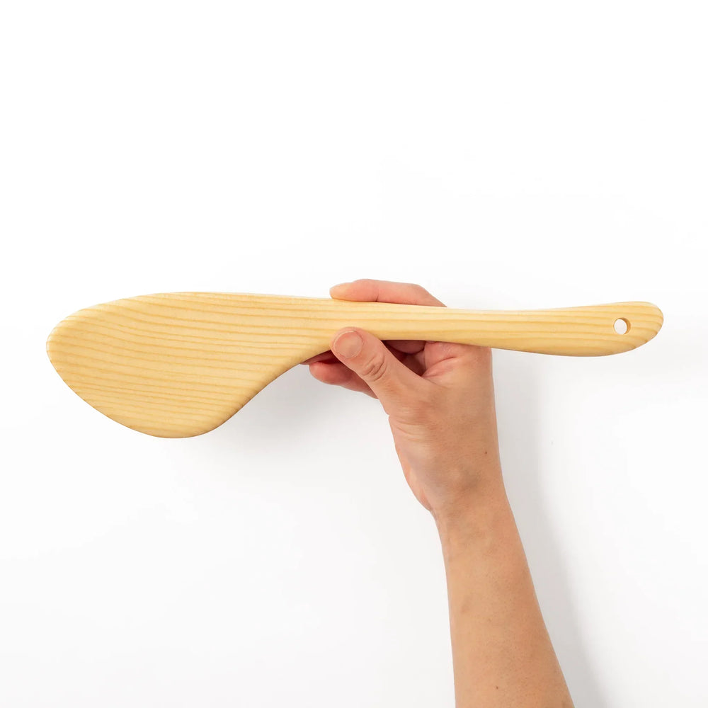 Lightweight hinoki wood spatula with fine grain and engraved Japanese handle for authentic kitchen use.