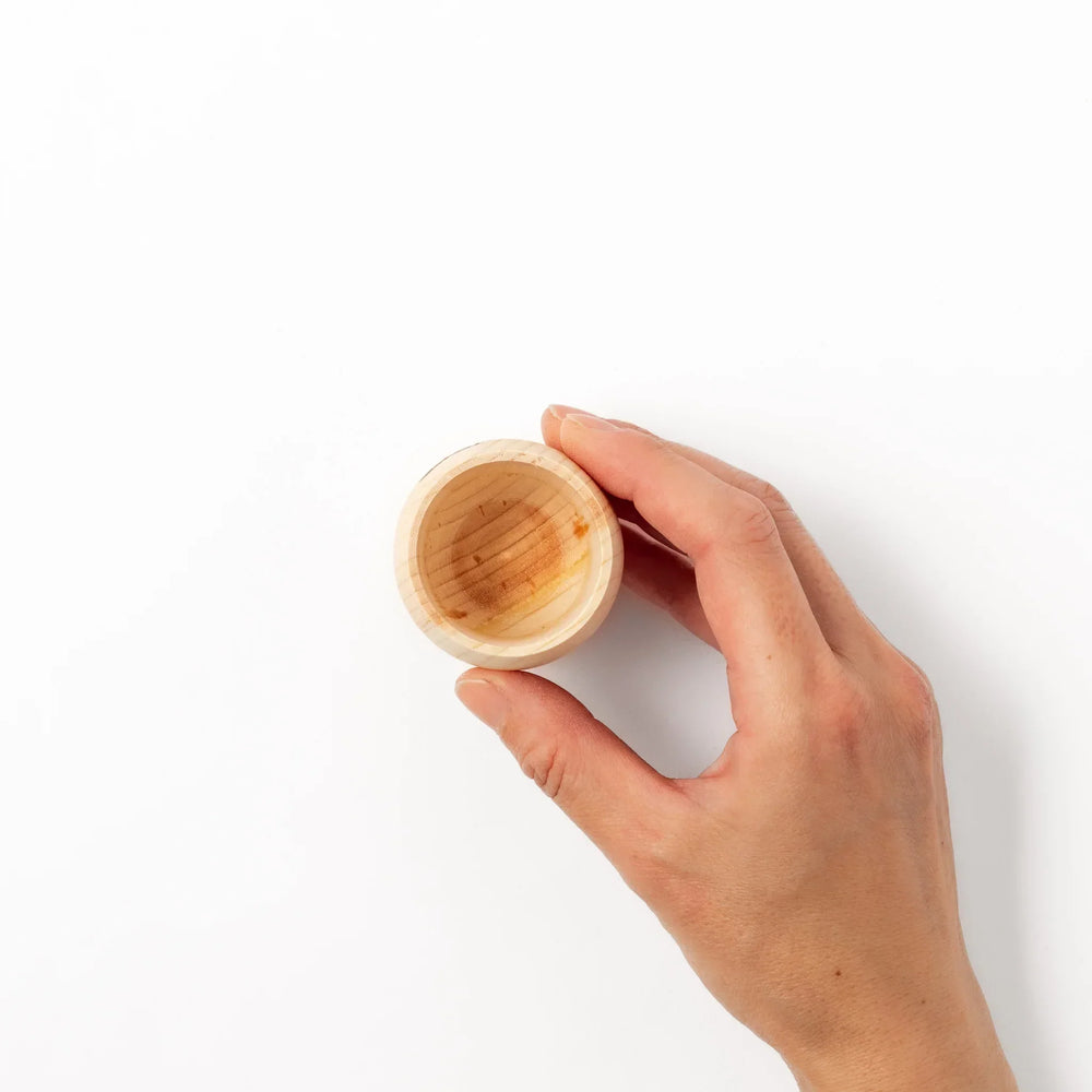 Hinoki wood sake set with carafe and two cups featuring burnt in designs for elegant Japanese sake rituals.