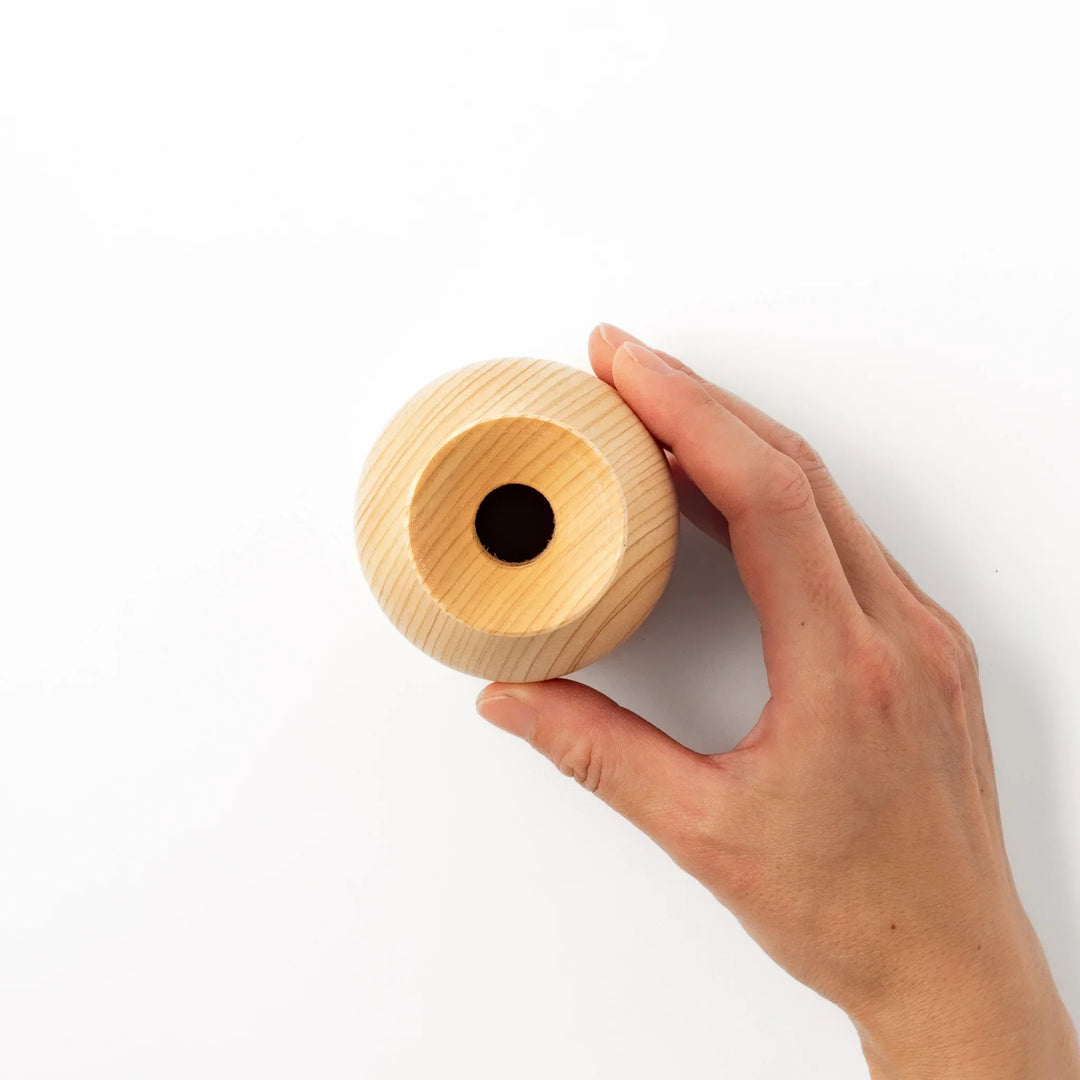 Hinoki wood sake set with carafe and two cups featuring burnt in designs for elegant Japanese sake rituals.