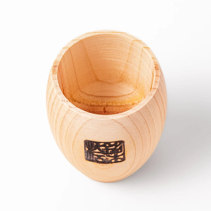 Hinoki wood sake set with carafe and two cups featuring burnt in designs for elegant Japanese sake rituals.