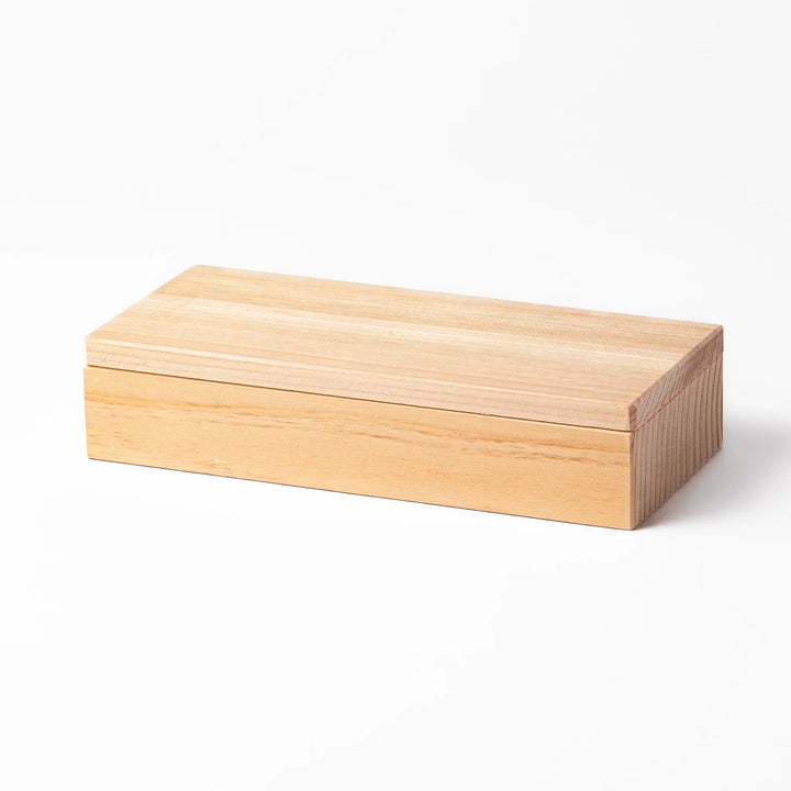Hinoki wood onigiri mold with two triangle cavities and lid for shaping aromatic Japanese rice balls.