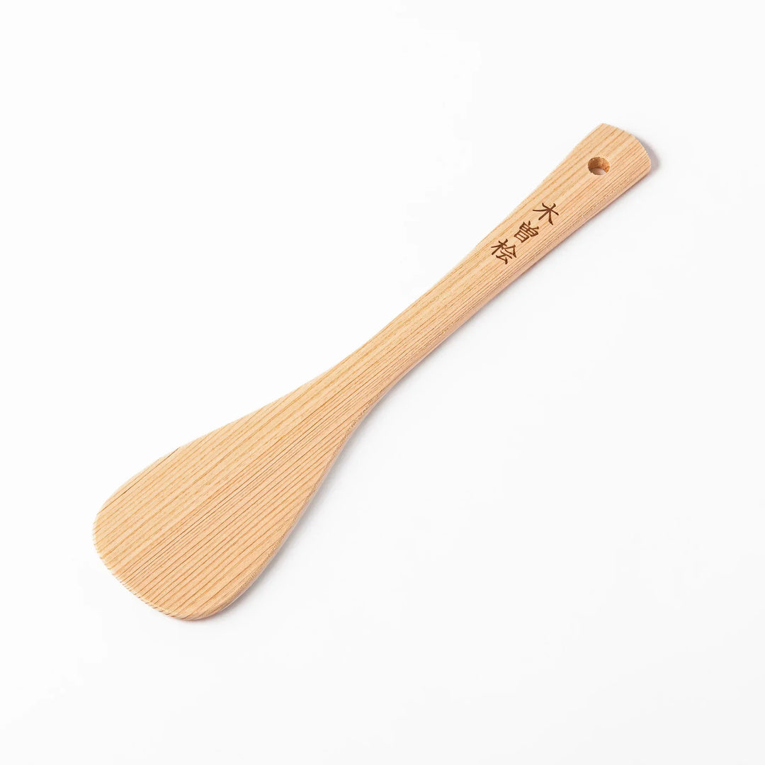 Lightweight hinoki wood spatula with fine grain and engraved Japanese handle for authentic kitchen use.