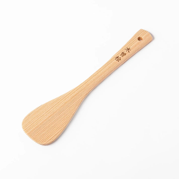 Lightweight hinoki wood spatula with fine grain and engraved Japanese handle for authentic kitchen use.