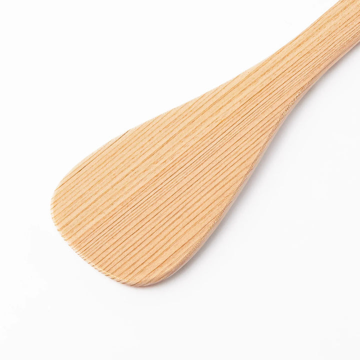 Lightweight hinoki wood spatula with fine grain and engraved Japanese handle for authentic kitchen use.