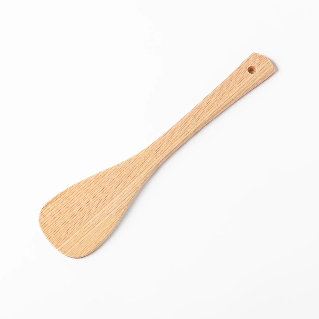 Lightweight hinoki wood spatula with fine grain and engraved Japanese handle for authentic kitchen use.