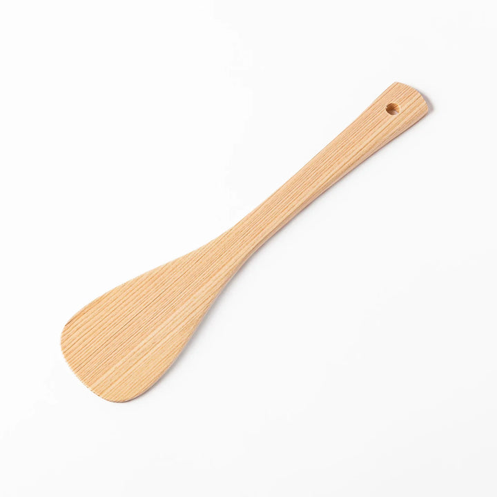 Lightweight hinoki wood spatula with fine grain and engraved Japanese handle for authentic kitchen use.