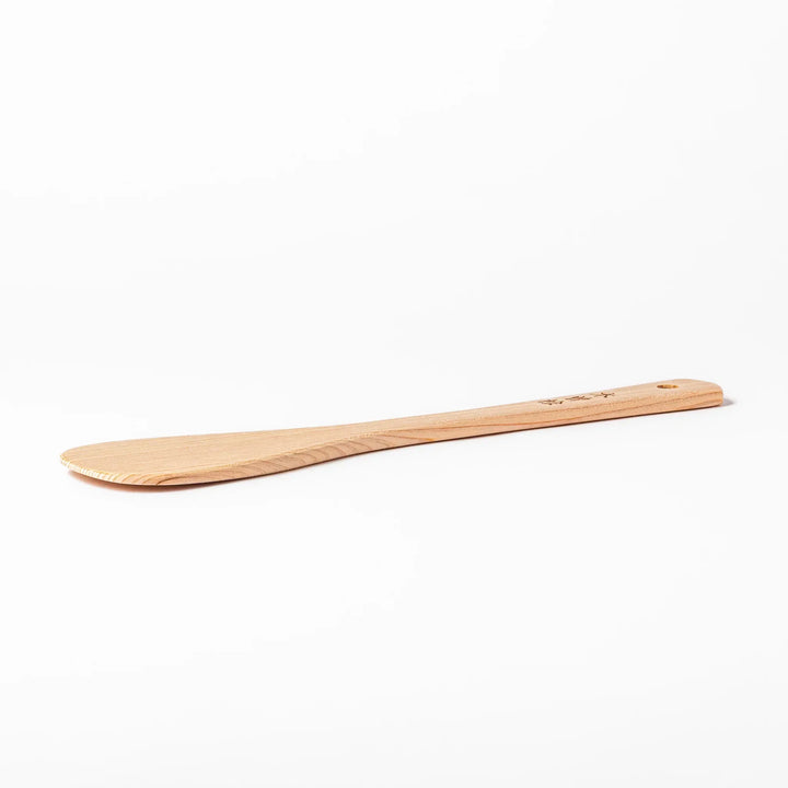 Lightweight hinoki wood spatula with fine grain and engraved Japanese handle for authentic kitchen use.