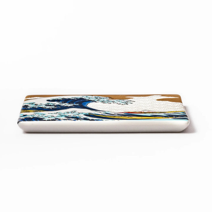 Square Japanese ceramic coaster with Hokusai Great Wave design featuring blue waves golden sky and Mt Fuji.