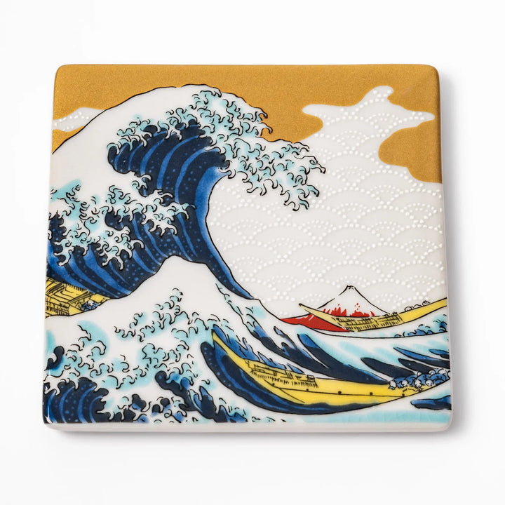 Square Japanese ceramic coaster with Hokusai Great Wave design featuring blue waves golden sky and Mt Fuji.