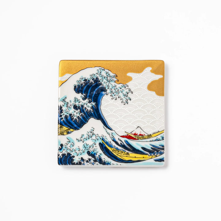 Square Japanese ceramic coaster with Hokusai Great Wave design featuring blue waves golden sky and Mt Fuji.