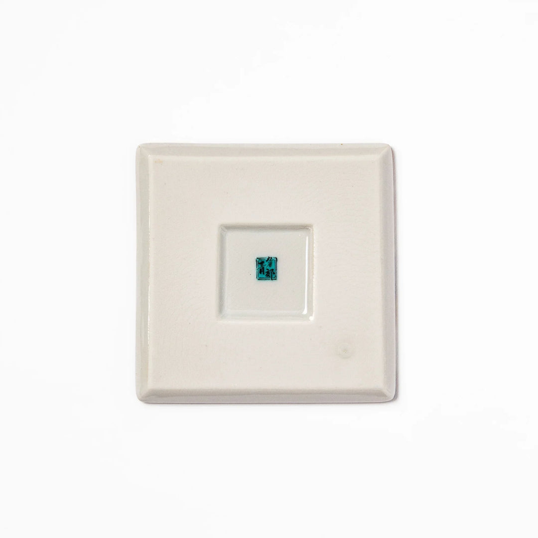 Square Japanese ceramic coaster with Hokusai Great Wave design featuring blue waves golden sky and Mt Fuji.