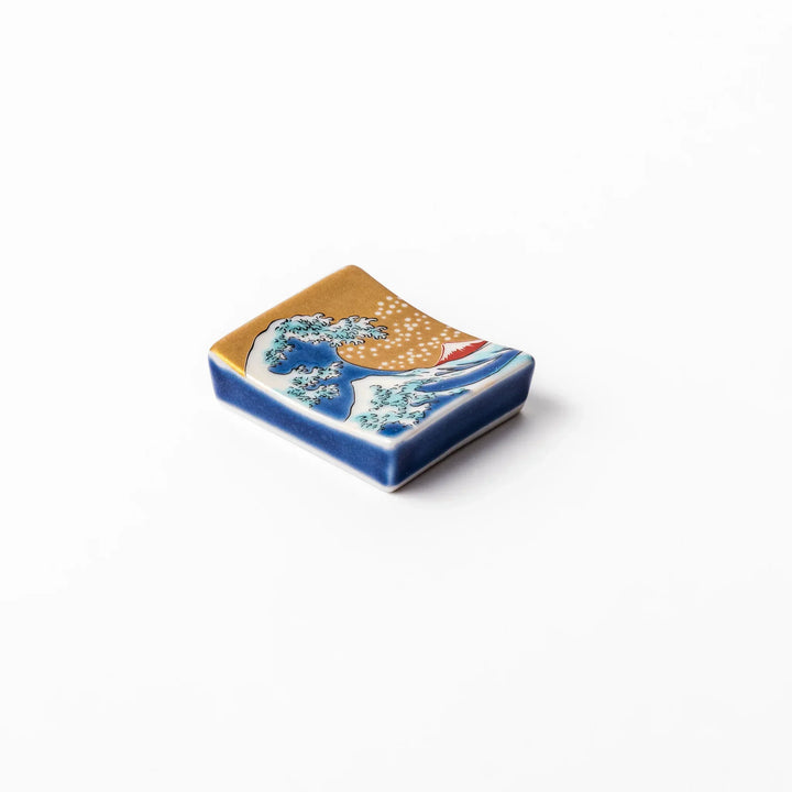 Rectangular Japanese ceramic chopstick rest with Hokusai Great Wave design blue wave golden sky Mt Fuji.