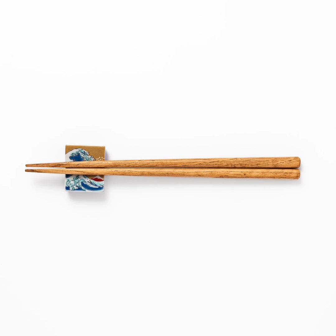 Rectangular Japanese ceramic chopstick rest with Hokusai Great Wave design blue wave golden sky Mt Fuji.