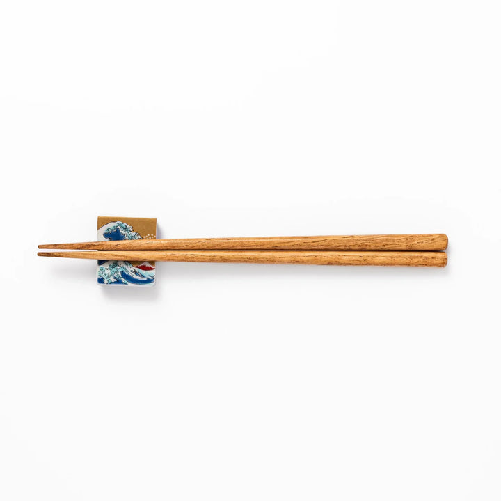 Rectangular Japanese ceramic chopstick rest with Hokusai Great Wave design blue wave golden sky Mt Fuji.