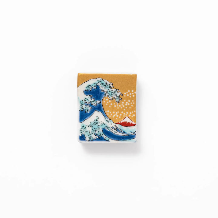 Rectangular Japanese ceramic chopstick rest with Hokusai Great Wave design blue wave golden sky Mt Fuji.