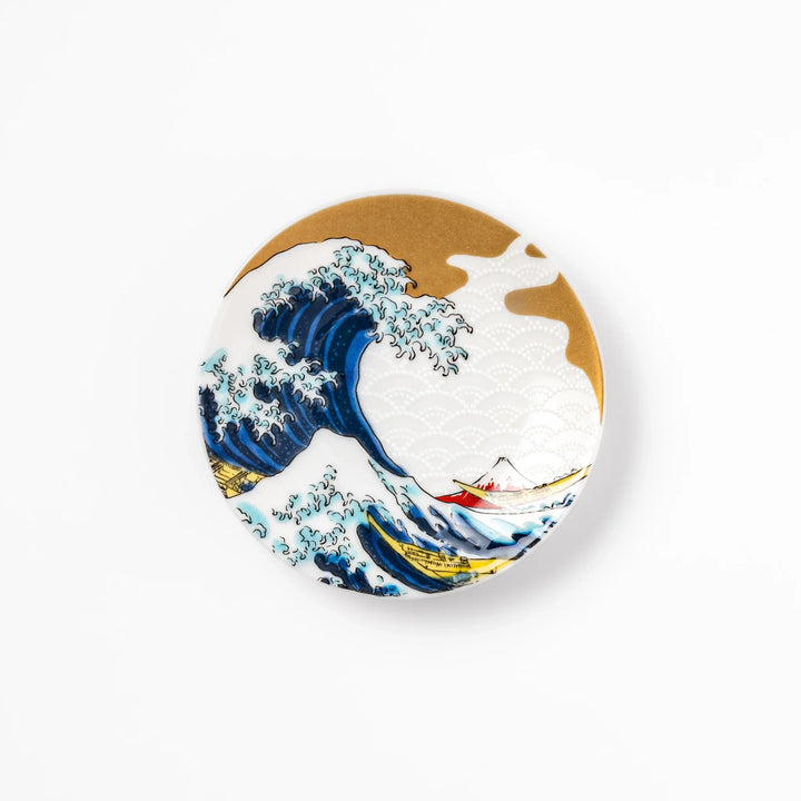 Round Japanese ceramic sauce dish with Hokusai Great Wave design showing blue waves golden sky and Mt Fuji.