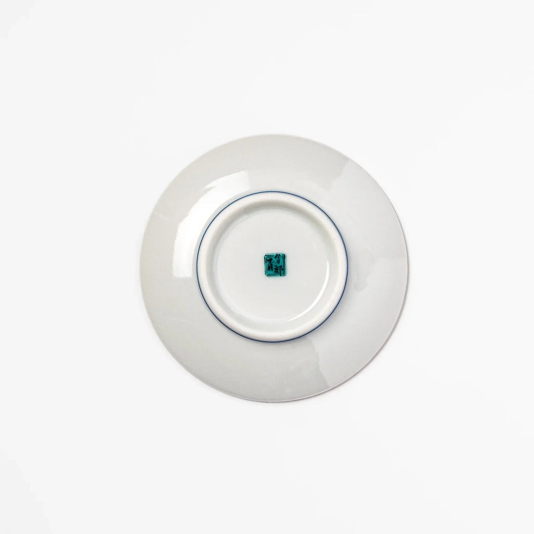 Round Japanese ceramic sauce dish with Hokusai Great Wave design showing blue waves golden sky and Mt Fuji.