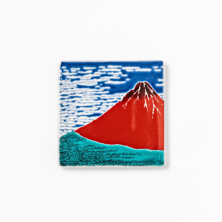 Square Japanese ceramic coaster with Hokusai Red Fuji design showing red mountain blue sky and white clouds.
