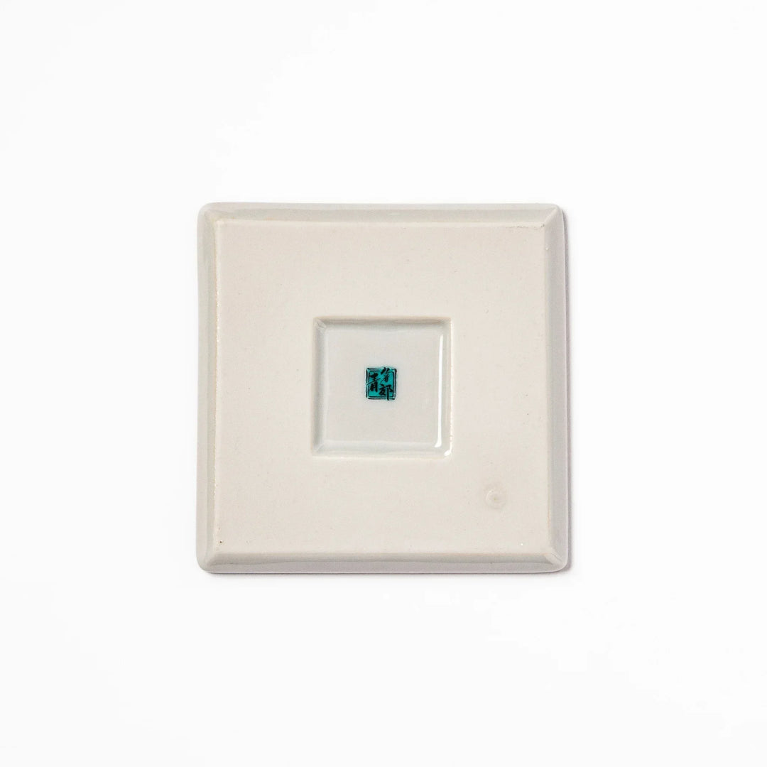 Square Japanese ceramic coaster with Hokusai Red Fuji design showing red mountain blue sky and white clouds.