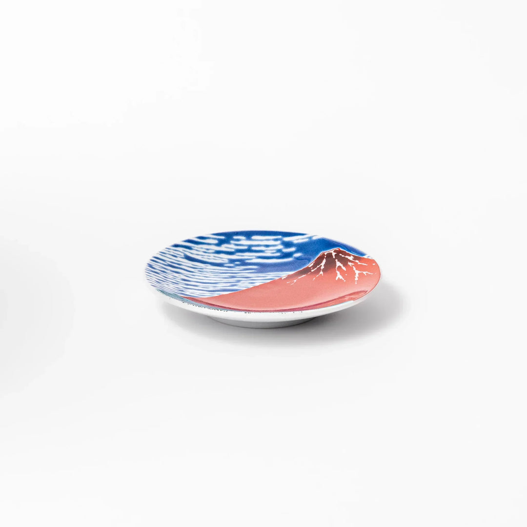 Round Japanese ceramic sauce dish with Hokusai Red Fuji design featuring red mountain blue sky and clouds.