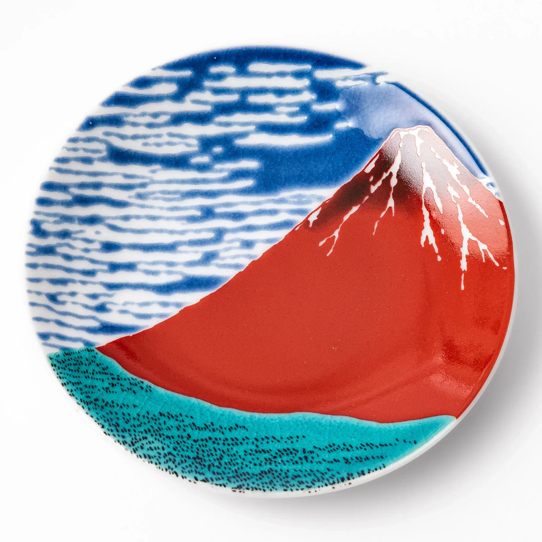 Round Japanese ceramic sauce dish with Hokusai Red Fuji design featuring red mountain blue sky and clouds.