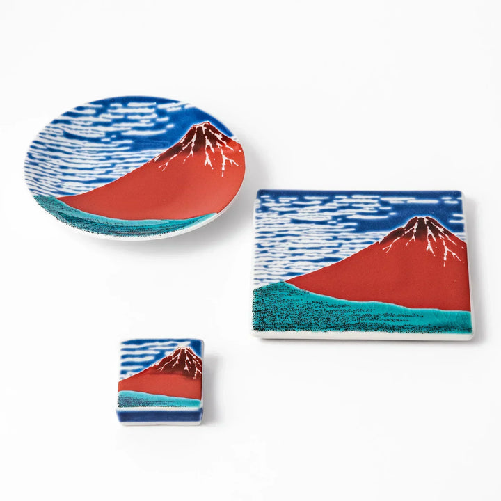 Japanese ceramic tableware set with Hokusai Red Fuji design including dish coaster and chopstick rest.