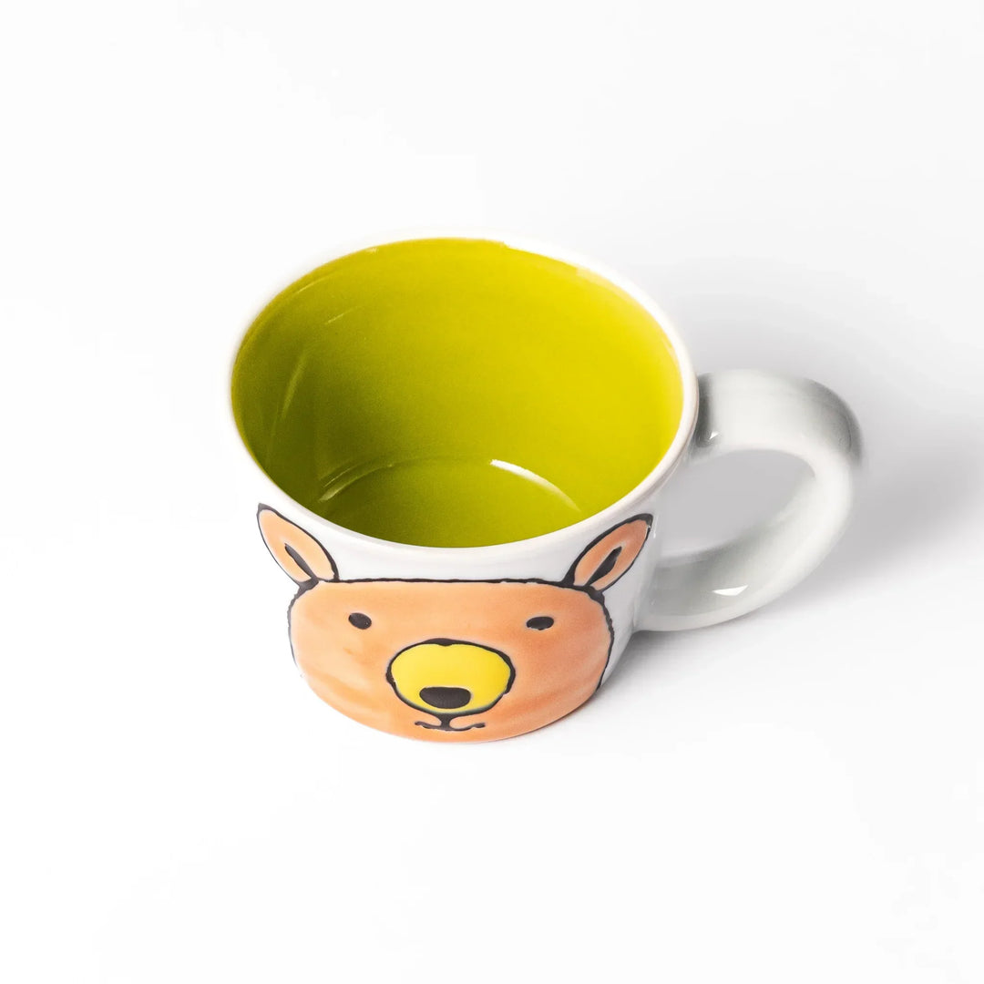 White ceramic kids mug featuring friendly honey bear face, yellow interior, round handle, shown on white background