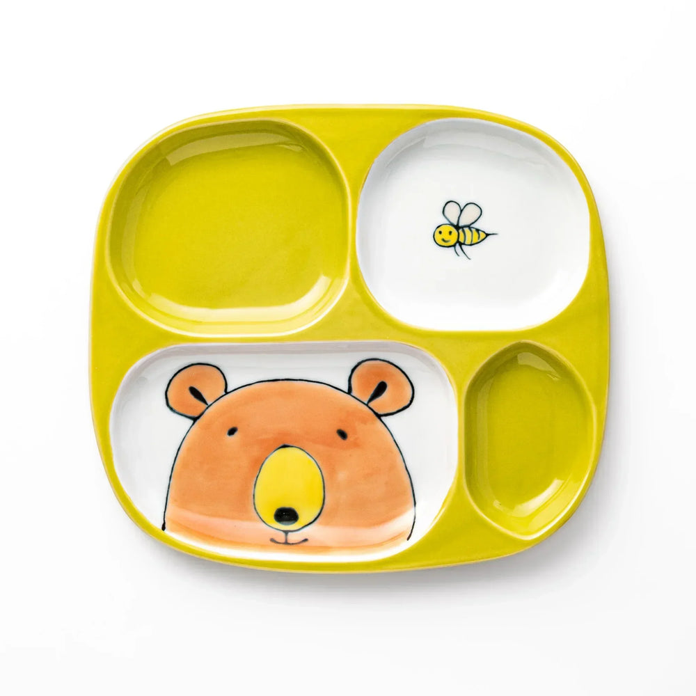 White ceramic kids plate with honey bear face in main section, bee motif in small section, chartreuse accents