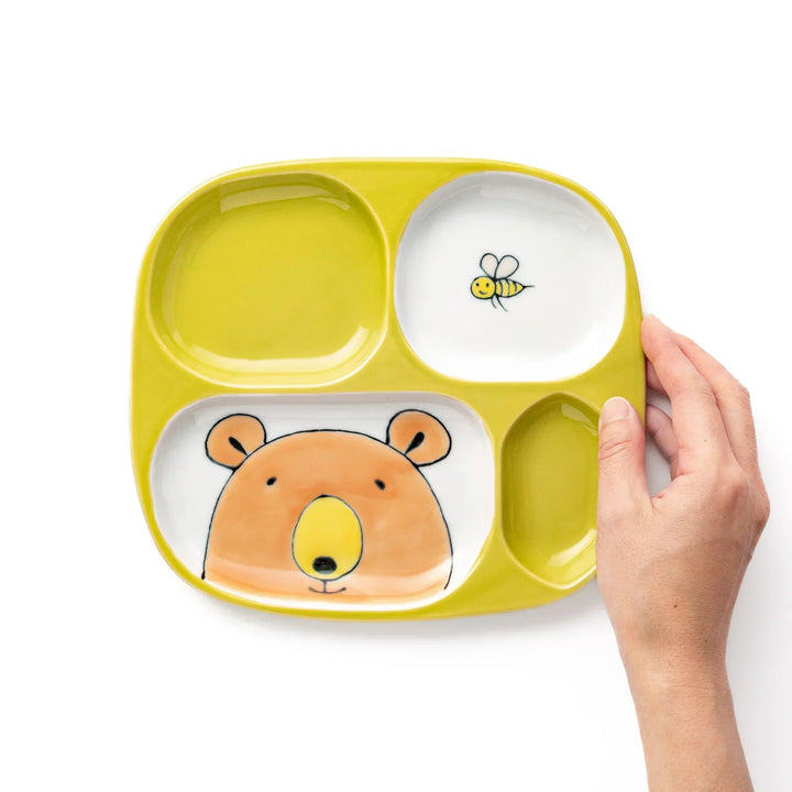 White ceramic kids plate with honey bear face in main section, bee motif in small section, chartreuse accents