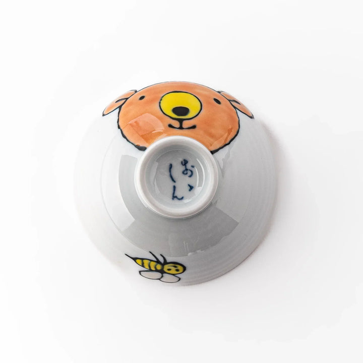 White ceramic kids rice bowl featuring honey bear face, chartreuse interior, round footed base