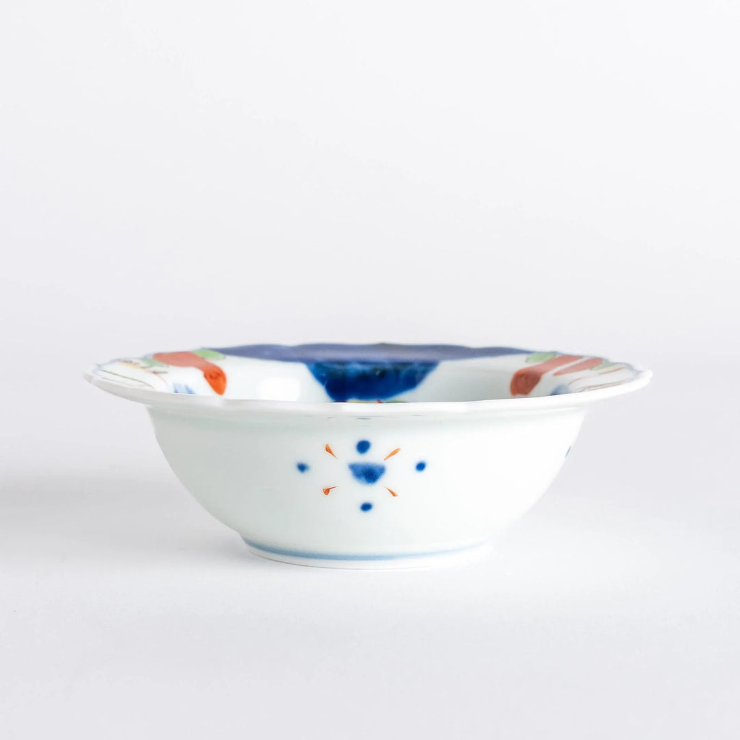 A small dessert bowl featuring colorful designs, including a galloping horse and abstract landscape motifs.