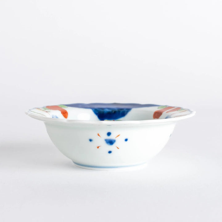 A small dessert bowl featuring colorful designs, including a galloping horse and abstract landscape motifs.