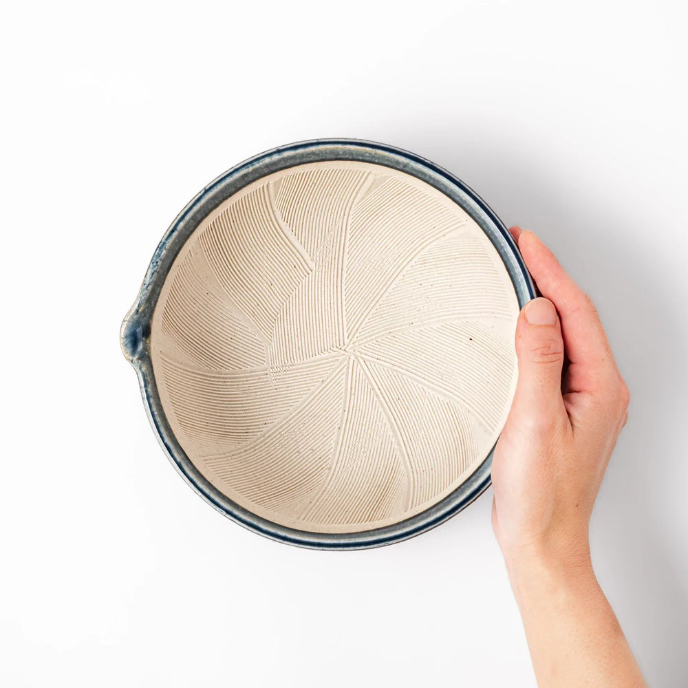 Indigo Japanese suribachi mortar with cream grooved interior and spout for grinding sesame herbs and spices.