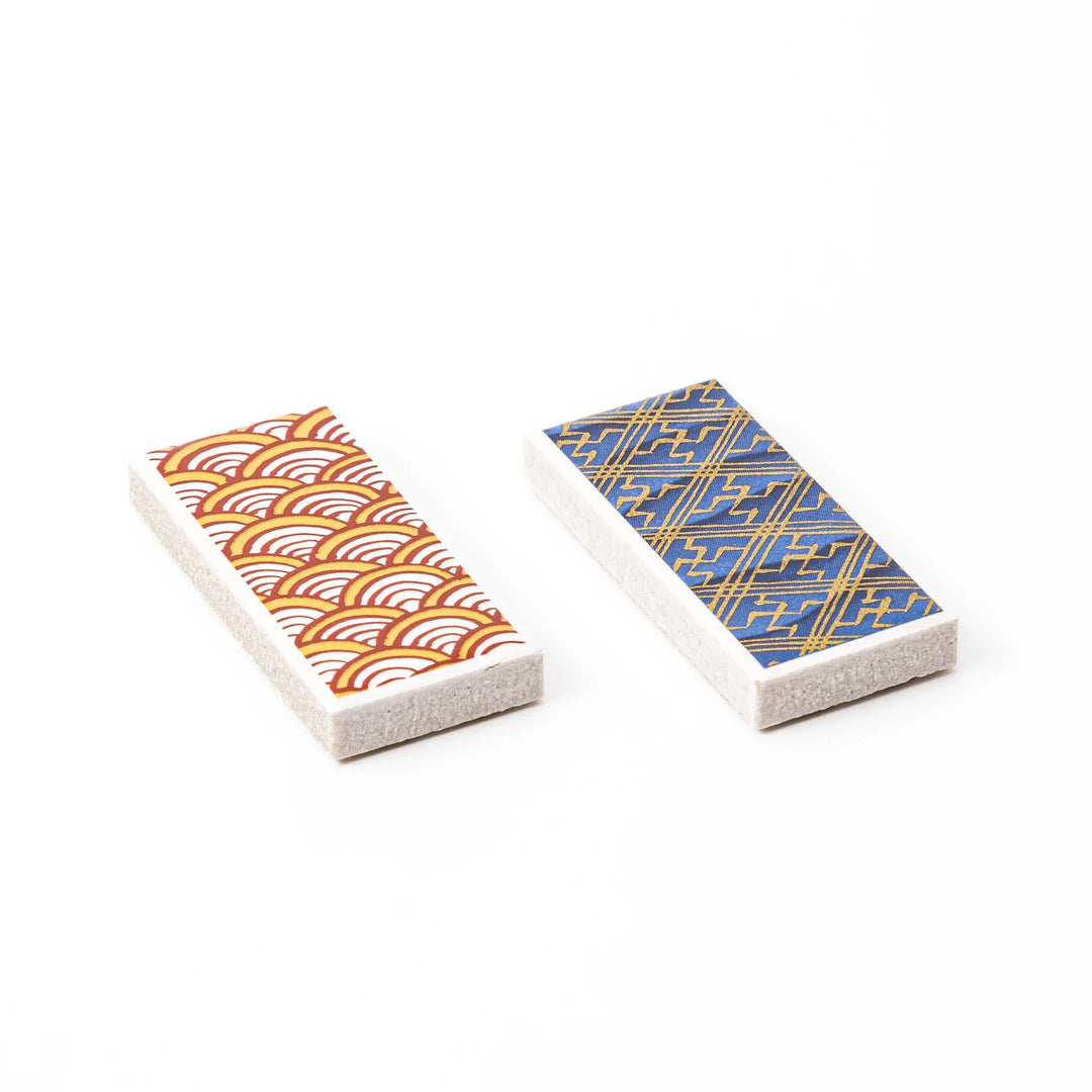 Two rectangular ceramic chopstick rests decorated with yellow wave and blue geometric traditional Japanese patterns