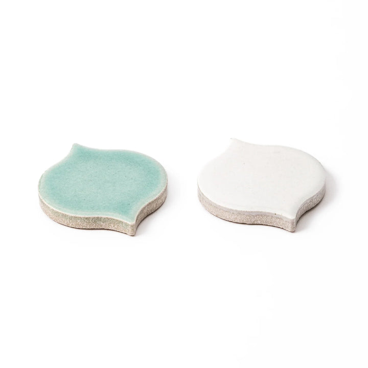 Two curved tile shaped ceramic chopstick rests in elegant light green and matte white matte finishes