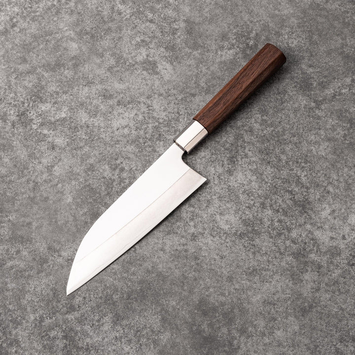 Japanese kitchen knife with cherry blossom cutout blade and dark wooden handle for precise cutting.