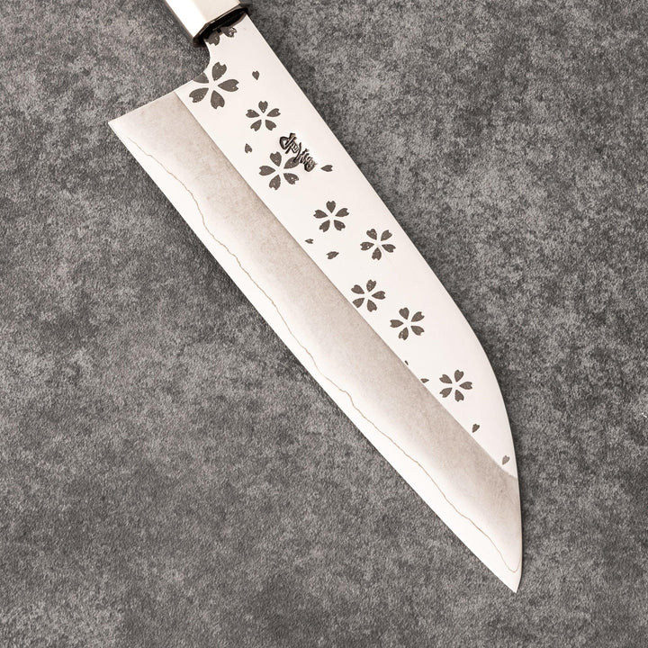 Japanese kitchen knife with cherry blossom cutout blade and dark wooden handle for precise cutting.
