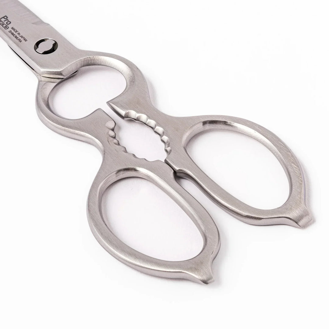 Japanese stainless steel kitchen shears with sharp blades and grip for cutting meat seafood and vegetables.