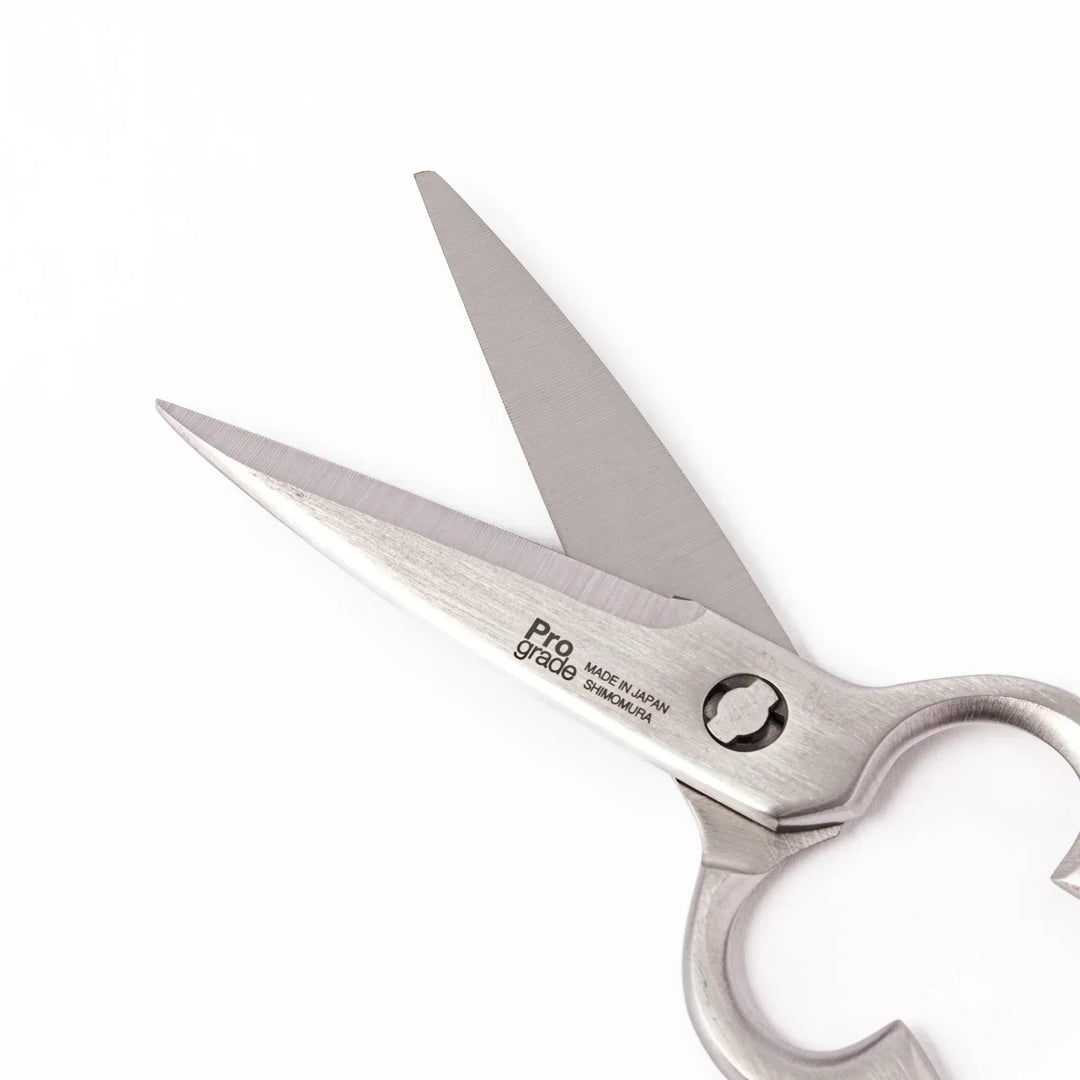Japanese stainless steel kitchen shears with sharp blades and grip for cutting meat seafood and vegetables.
