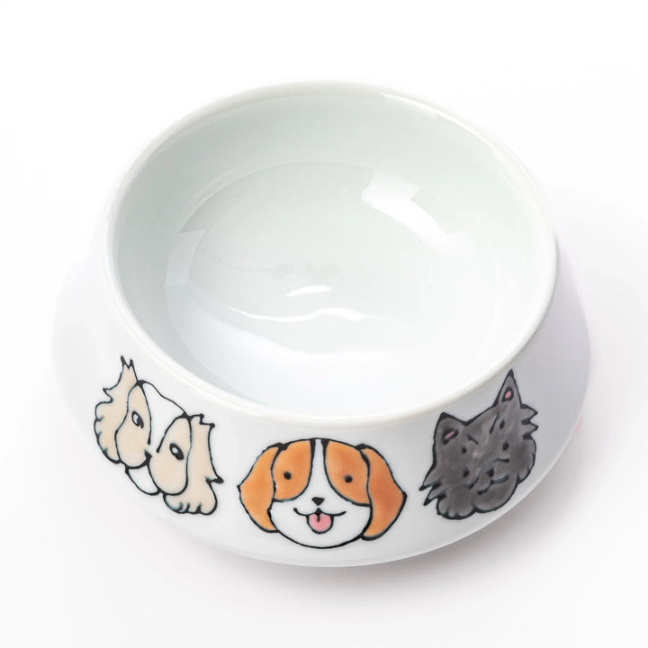 Japanese ceramic dog bowl with hand painted dog face designs and raised rim for pets