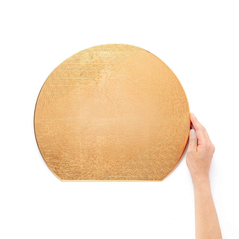 Gold Japanese Asanoha hemp leaf placemat with semicircular shape and embossed pattern for elegant table.
