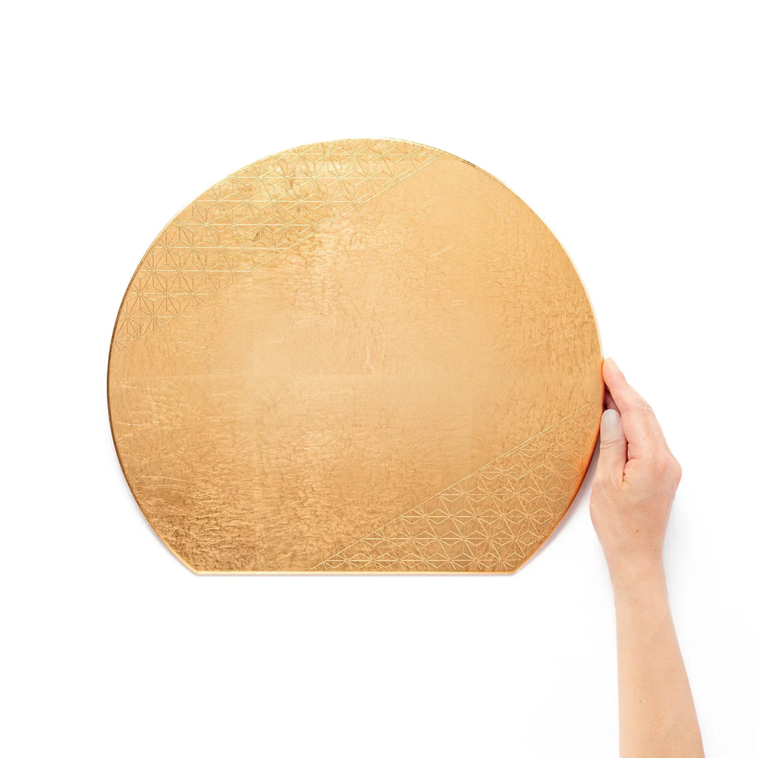 Gold Japanese Asanoha hemp leaf placemat with semicircular shape and embossed pattern for elegant table.