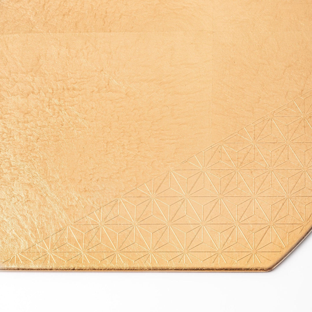 Gold Japanese Asanoha hemp leaf placemat with semicircular shape and embossed pattern for elegant table.