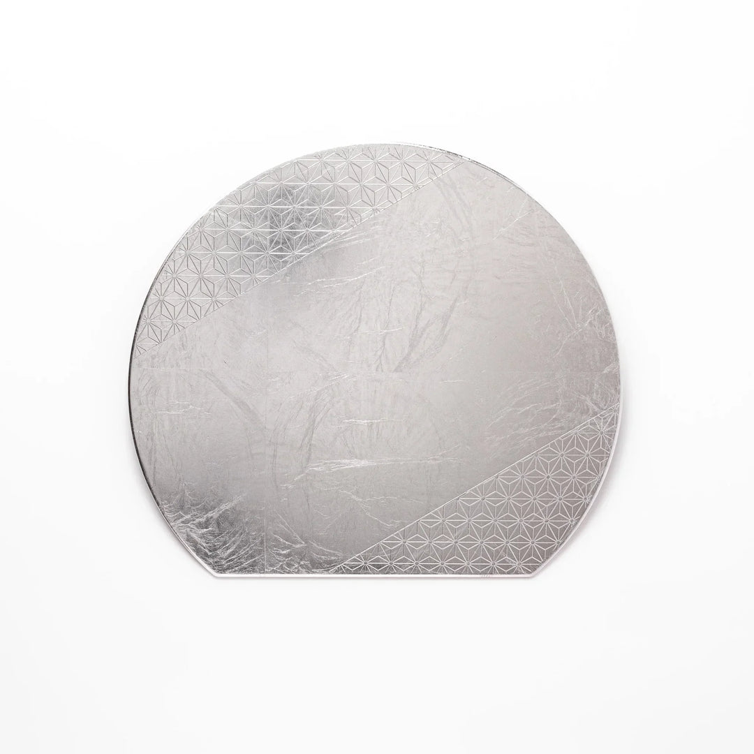 Silver Japanese Asanoha hemp leaf placemat with semicircular shape and embossed pattern for refined table.